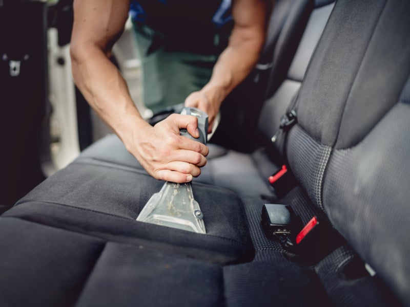 Close-up of car seat being cleaned